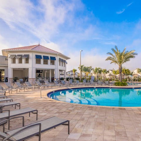 Relax on a sun lounger by the shared pool