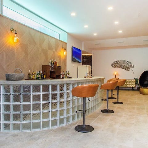 Practise your cocktail-making skills at the impressive bar