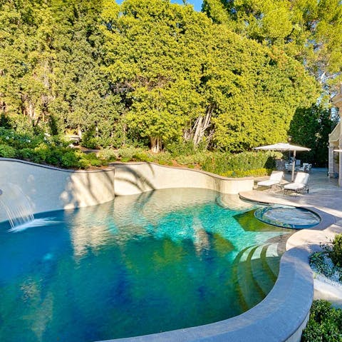 Cool off in the freeform private pool with hot tub and waterfall