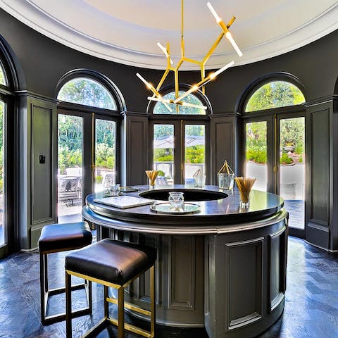 Mix a few cocktails at the wet bar, with doors opening to the terrace