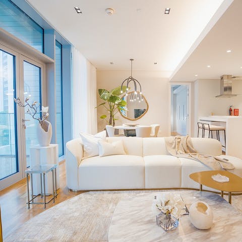 Unwind in style and admire the city lights through the floor-to-ceiling windows