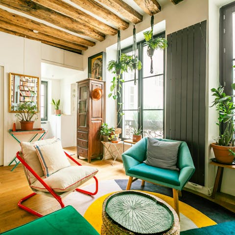 Curl up with a glass of wine amid plants and pretty furnishings