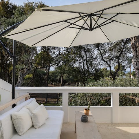 Step out of the bedroom onto the private balcony to relax amongst the trees