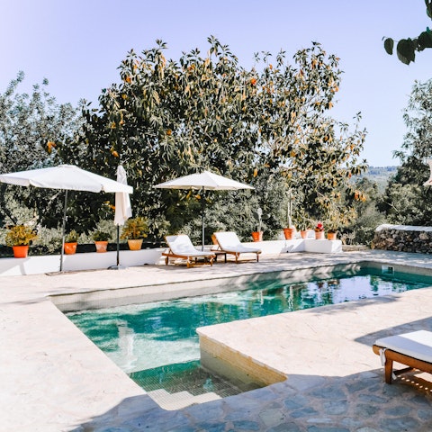 Laze on loungers in the sun or shade on the poolside terrace