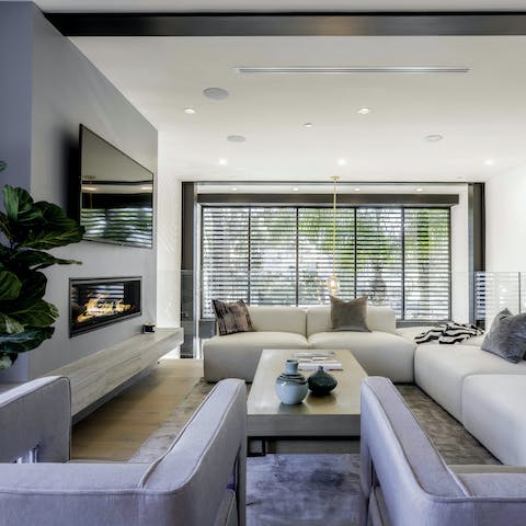 Gather everybody around the contemporary fireplace in the living room and put a movie on