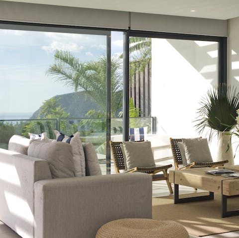 Relax in the peaceful lounge area while enjoying views through the floor-to-ceiling windows