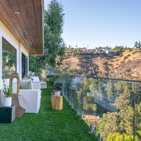 Take in scenic views over the hills from the private balcony