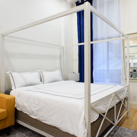 Get comfy in the modern four-poster bed for a great night's sleep