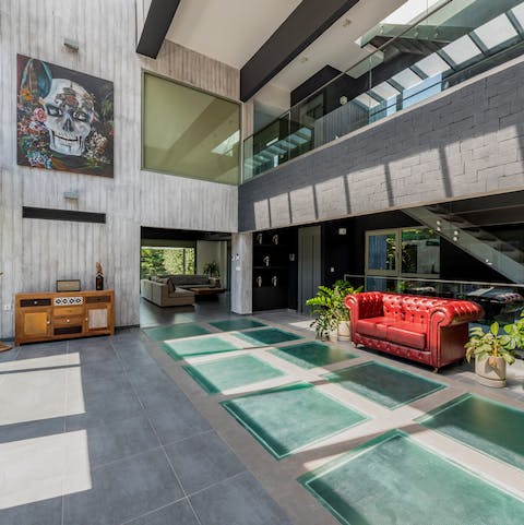 Marvel at the atrium room with its triple-height ceiling and wall of glass