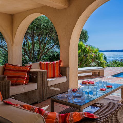 Recline on comfy seats in the shaded, porticoed lounge area