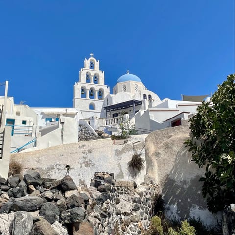Wander about the traditional Santorinian architecture in Pyrgos, only a quarter of