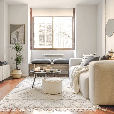Kick back in the bright boho living room, a glass of wine in hand