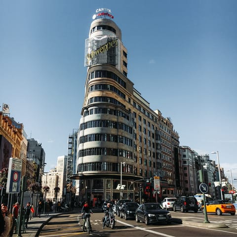 Admire the grand architecture along Gran Vía, a twenty-minute walk away