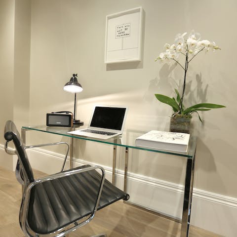Catch up on emails at the stylish glass desk