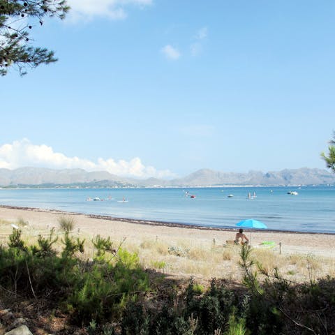 Stroll along the golden sands of Platja de San Pere, a five-minute drive from your villa