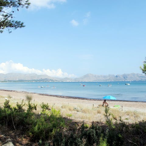 Stroll along the golden sands of Platja de San Pere, a five-minute drive from your villa