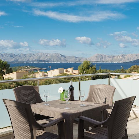 Sip a glass of wine and watch the sun dip behind the mountains