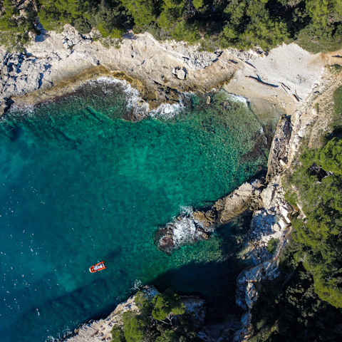 Explore Pula's beaches, a twenty-minute drive away