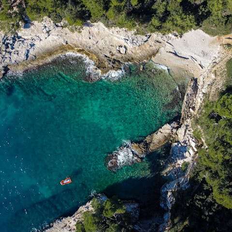 Explore Pula's beaches, a twenty-minute drive away
