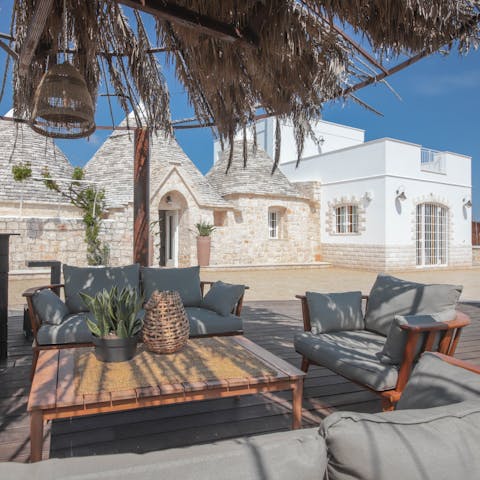 Sip cocktails as the sun sets before cooking in the outdoor kitchen