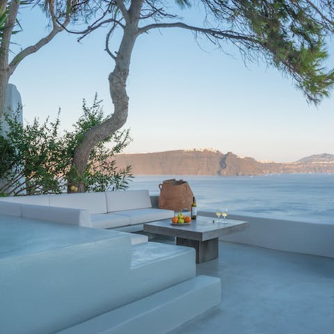 Share a bottle of wine on the terrace and watch the sun go down on the water