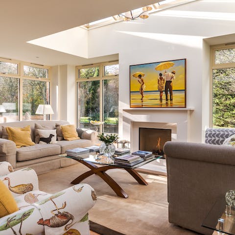 Fire up the remote-controlled fireplace and relax in the modern sunroom