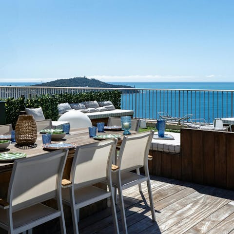Dine alfresco with sweeping views over the riviera