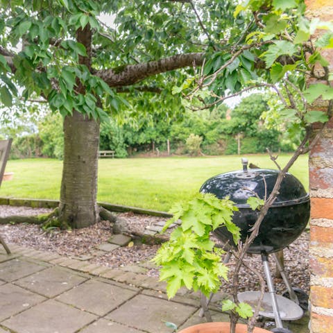 Fire up the charcoal barbecue and dine alfresco under the pergola