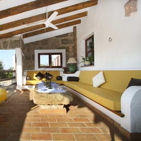 Relax under the gentle shade of the terrace with a glass of Spanish wine