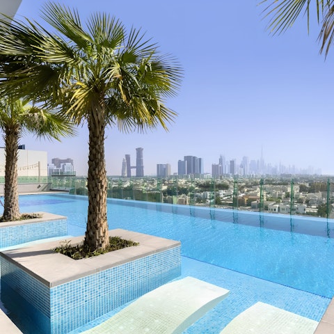 Admire views of the city of Dubai from the shared rooftop infinity pool