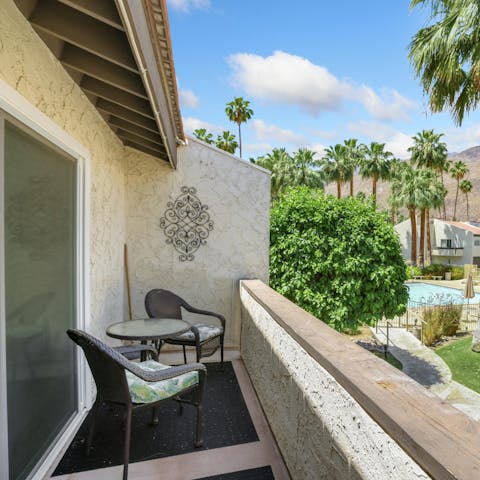 Enjoy your morning coffee on the balcony overlooking the palm trees
