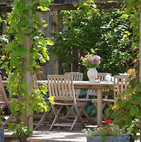 Enjoy lunches and dinners outside under the vine-covered pergola