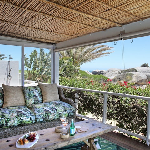Chill out on plush furniture on the veranda while enjoying captivating Cape Town views