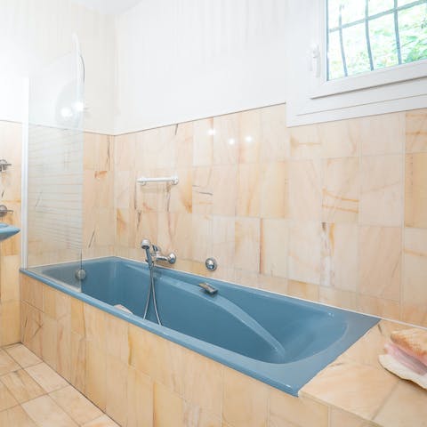 Lie back and relax after a long day in one of the home's bathtubs