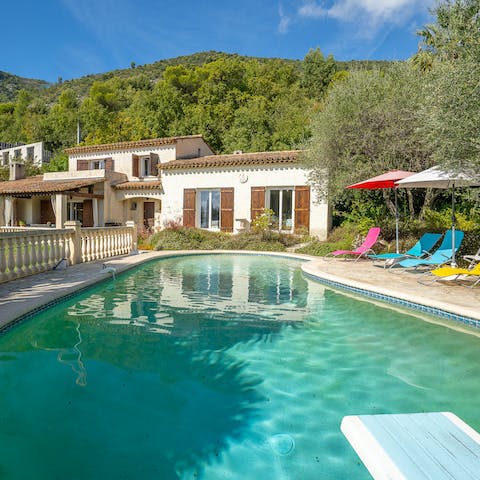 Jump into the kidney-shaped swimming pool from the diving board