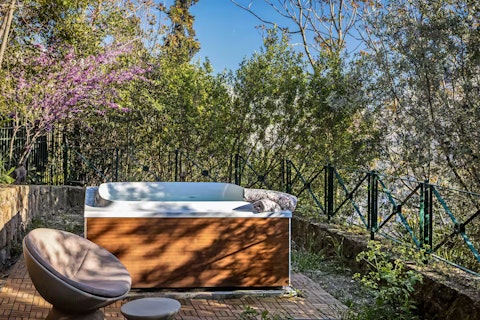 Step into the hot tub as the garden settles into stillness