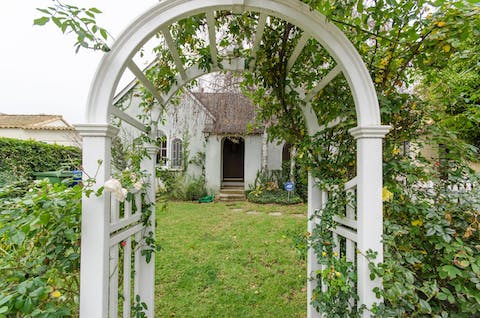 Peak at the pretty home through the rose arch