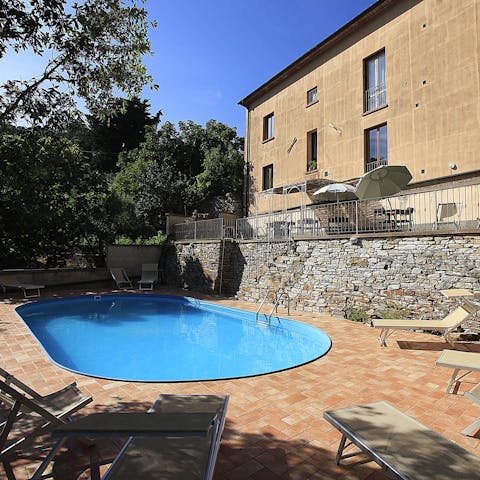 Relax in the Tuscan sun next to the communal pool