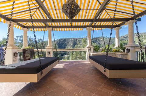 The swinging daybeds under the canopy