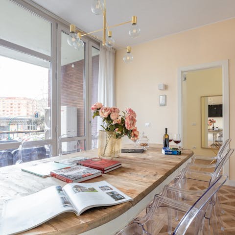 Come together around the wooden dining table with elegant ghost chairs