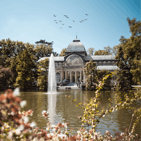 Take an afternoon stroll through El Retiro Park, a fifteen-minute walk away