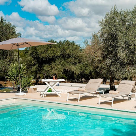 Lounge by the private pool on a sunny afternoon