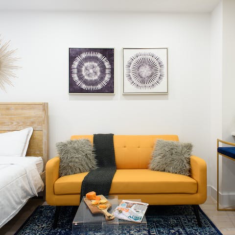Kick back on the bright yellow sofa with a glass of wine after a day of exploring the Big Apple