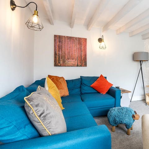 Sprawl out and put your feet up on the blue sheep footstool after a long day