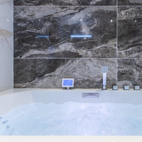 Treat yourself to an indulgent bath and hydrotherapy in the luxurious bathroom