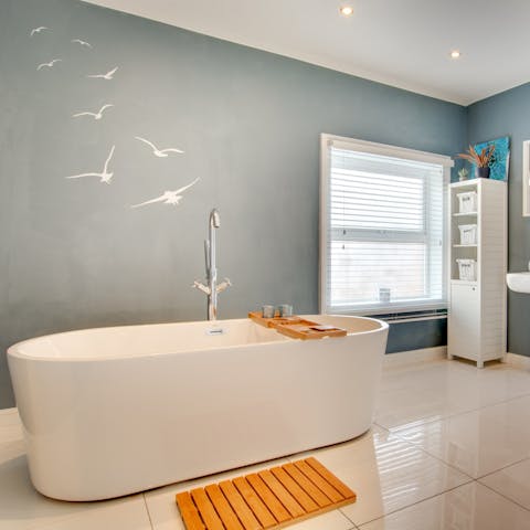 Close your eyes and sink back into steamy water in the freestanding bathtub