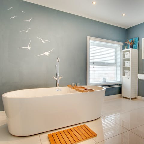 Close your eyes and sink back into steamy water in the freestanding bathtub