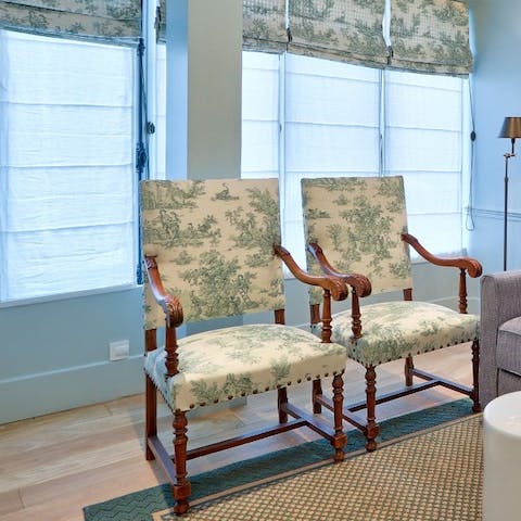 Sink into an elegant armchair dressed in Toile