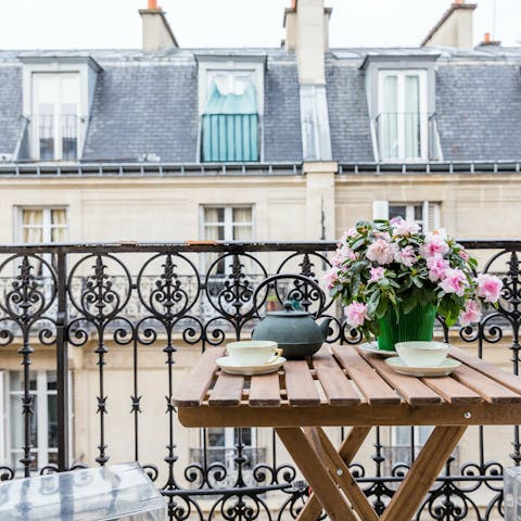 Embrace timeless French charm with tea on the balcony