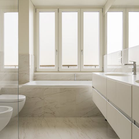 Watch the sunset from a hot bubble bath in the marble bathroom